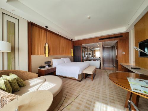 a hotel room with a bed and a table at JW Marriott Hotel Zhejiang Anji in Anji