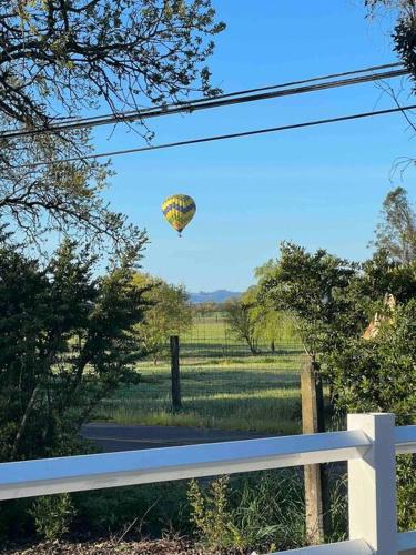 a kite flying in the sky over a field at Wine Country - Country home 