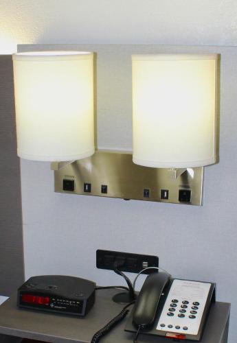 a desk with two lamps and a telephone on it at Ramada by Wyndham Harrisonburg in Harrisonburg