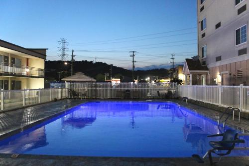 a large blue swimming pool next to a building at Ramada by Wyndham Harrisonburg in Harrisonburg