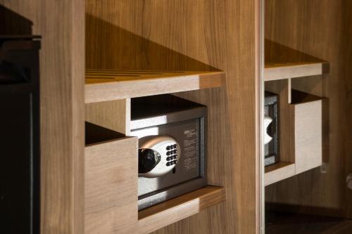 a microwave oven in a wooden kitchen cabinet at Just Sleep Hualien ZhongZheng in Hualien City