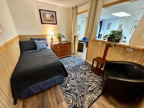 a bedroom with a bed and a desk and a chair at Alaska Angler's Inn in Soldotna