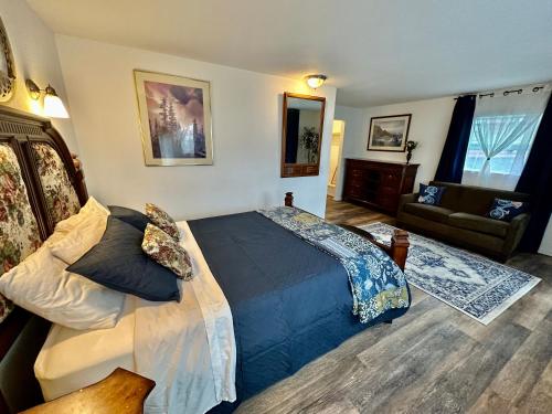a bedroom with a bed and a living room at Alaska Angler's Inn in Soldotna