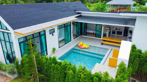 an aerial view of a house with a swimming pool at Villa Paramount 1 in Nakhon Nayok