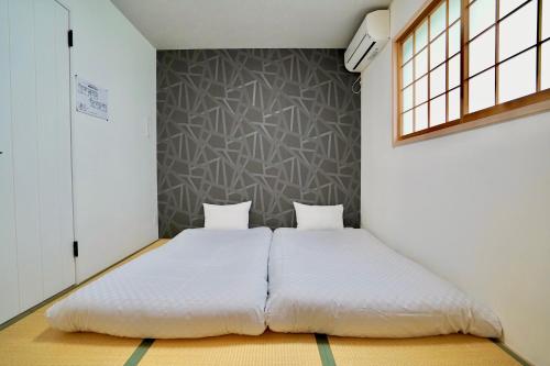 Un pat sau paturi într-o cameră la Haku Tofukuji
