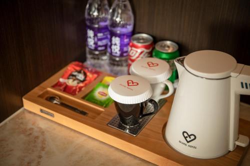 a counter with a coffee maker and a blender at Dijing Hotel Shanghai in Shanghai