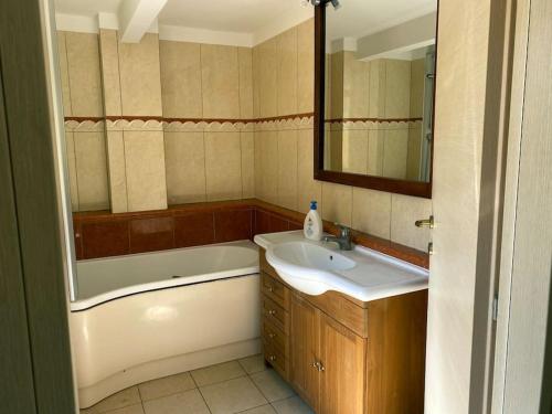 a bathroom with a tub and a sink and a bath tub at Terraced House near the Sea in Livorno