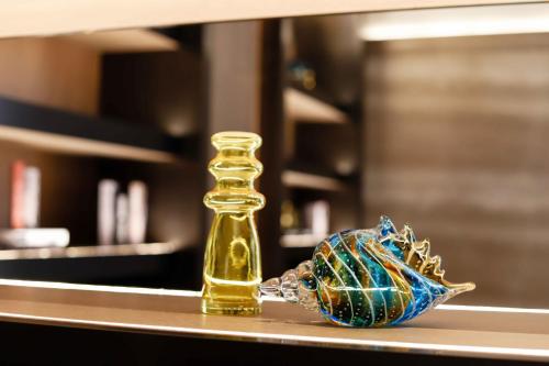 a small glass bottle on a counter with a small at Pullman Haikou in Haikou