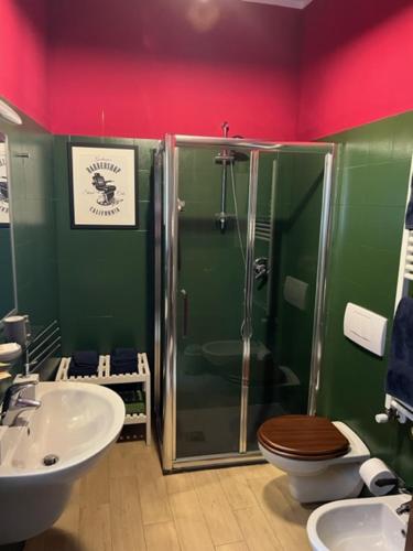 a bathroom with a shower and a toilet and a sink at Residence Griffoni in Bologna