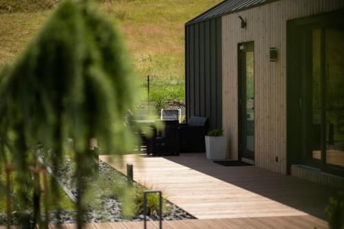 an outside view of a building with a wooden deck at ChillZone-Hill in Szalejów Górny