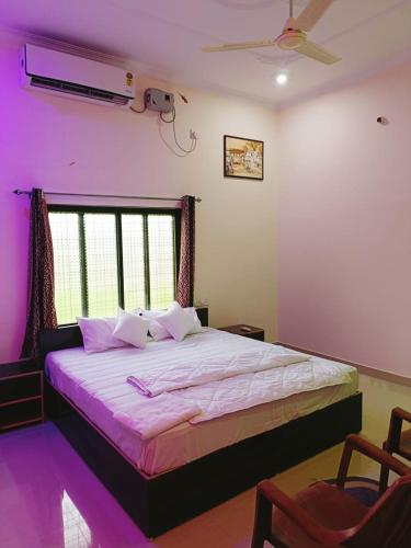 a bedroom with a large bed and a window at The Mountain View Home Stay in Khajurāho