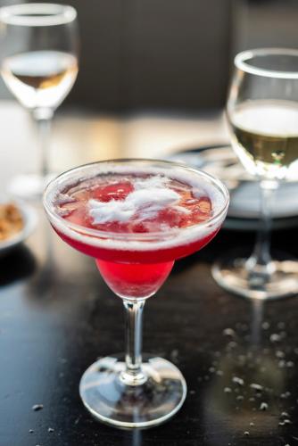 a red drink in a wine glass on a table at Park Proxi Gibraltar Bowral in Bowral