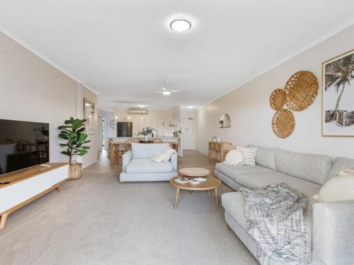 a living room with a couch and a table at Kingscliff Paradise with Ocean Views in Kingscliff