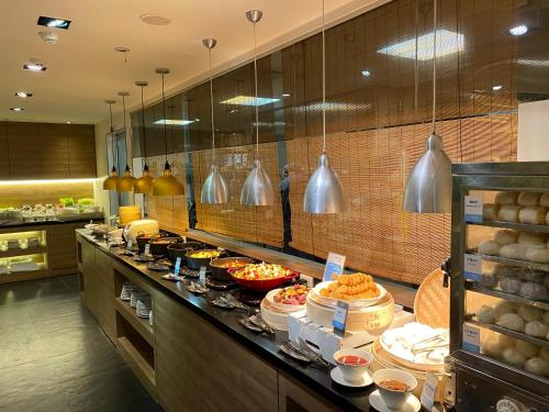 a kitchen with a counter with food on it at Just Sleep Hualien ZhongZheng in Hualien City