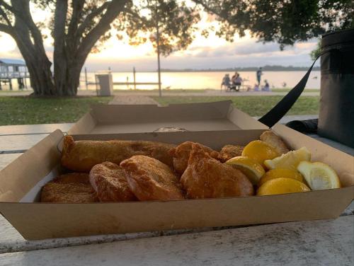 a box of pastries and fruit on a table at Bribie Getaway in Bongaree