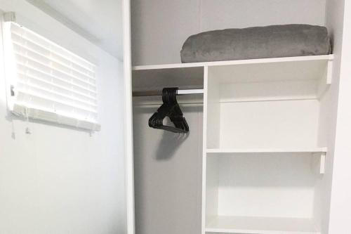 a closet with a shelf with a shoe on it at Bribie Getaway in Bongaree
