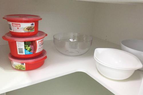 a counter with three containers of food and a bowl at Bribie Getaway in Bongaree