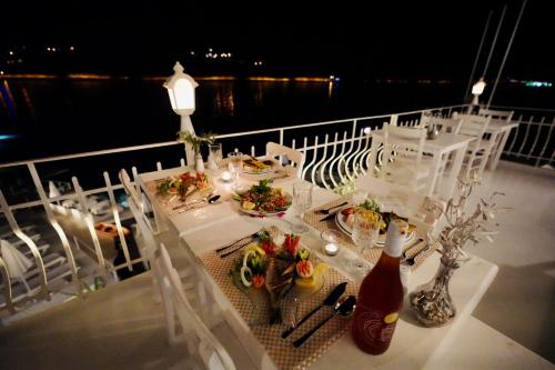 a dining table on a cruise ship at night at Club Çapa Hotel in Kas