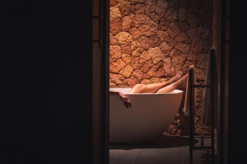 a person in a bath tub with their legs in it at Kizikula in Kizimkazi