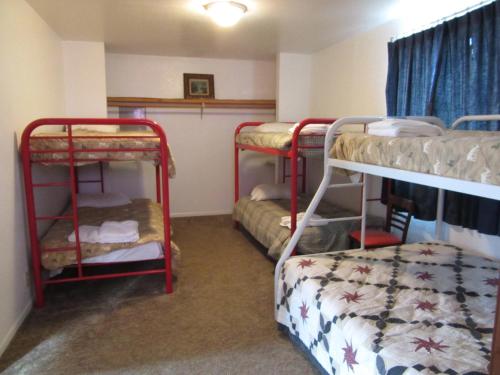 a room with three bunk beds in a room at All Seasons Campground in Ninilchik