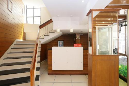 a staircase in a building with wooden walls and a stair case at Hotel Ganesh in Trivandrum