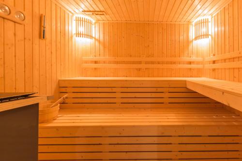 a sauna with wooden floors and steps in it at Kantary Hotel Korat in Nakhon Ratchasima