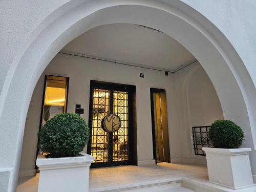 an archway leading to a door with a clock at Rosetti One in Constanţa