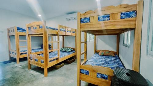 a bedroom with three bunk beds in a room at Beach House, San Juan, La Union in San Juan