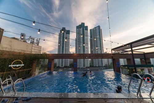 a swimming pool with a city skyline in the background at Park Marine Hotel in Incheon