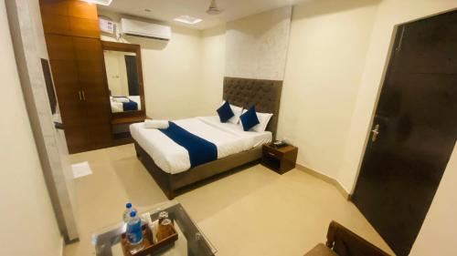 a hotel room with a bed and a mirror at Hotel Landmark in Chandīgarh