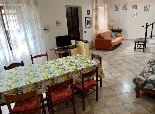 a living room with a table and a couch at Casa Serbariu, Sud Sardegna - Carbonia in Carbonia