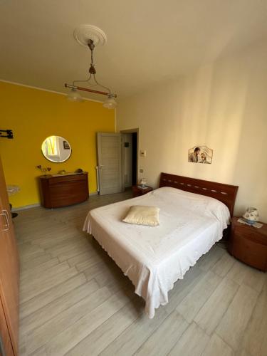 1 dormitorio con cama y pared amarilla en Salernobnb, en Salerno