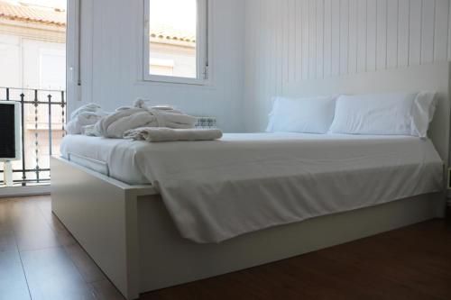 a white bed with towels sitting on top of it at MonResidence Bellavista in Manresa
