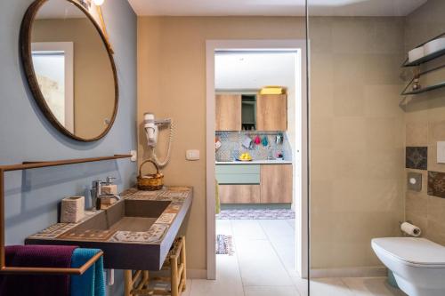 a bathroom with a sink and a mirror at La dimora Elia' in Muro Leccese