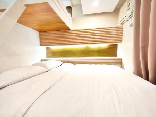 a bedroom with a white bed in a room at Topaz 1 Bedroom Suite Orochi Staycation PH at Centrio Towers in Cagayan de Oro