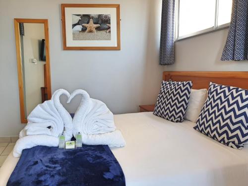 a room with a bed with towels on it at Gooderson Leisure Silver Sands 1 Self Catering and Timeshare Lifestyle Resort in Durban