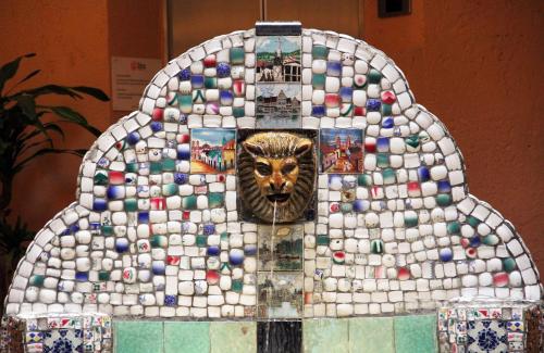 a mosaic structure with a lion head on it at Hotel Templo Mayor in Mexico City