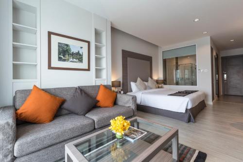 a living room with a couch and a bed at Kantary Hotel Korat in Nakhon Ratchasima