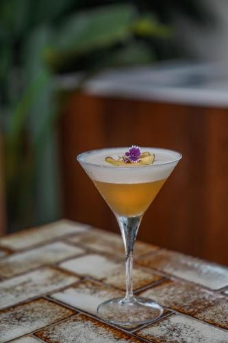 a martini glass with a flower on a table at Hotel Pulitzer Barcelona in Barcelona