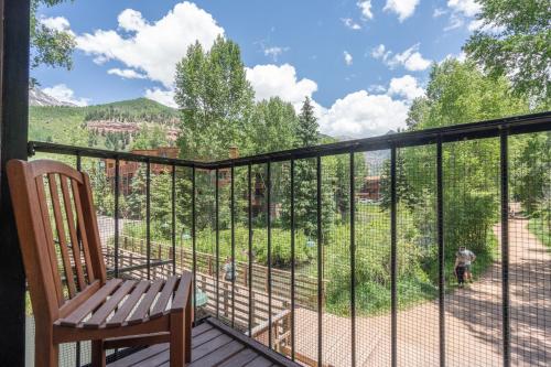 a balcony with a chair and a view of a yard at Manitou Lodge 5 Hotel Room in Telluride