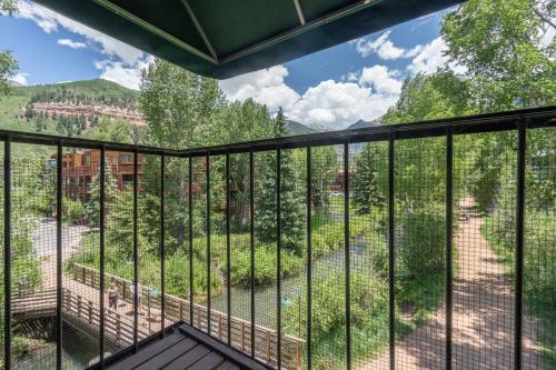 a balcony with a view of a forest at Manitou Lodge 5 Hotel Room in Telluride