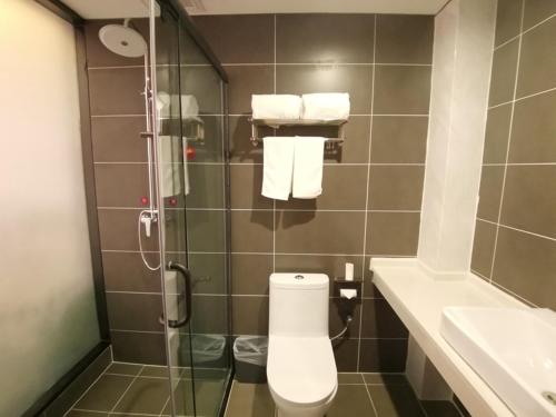 a bathroom with a shower with a toilet and a sink at JUN Hotels Shanxi Yuncheng Yongji Bus Station in Yuncheng