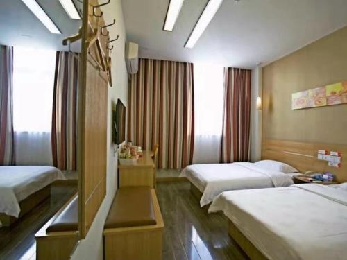 a hotel room with two beds and a window at Thank Inn Chain Hotel Henan Luoyang Longmen Avenue Guanlin Road in Luoyang