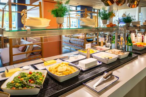 a buffet line with various foods and drinks at ibis Paris Coeur d'Orly Airport in Orly