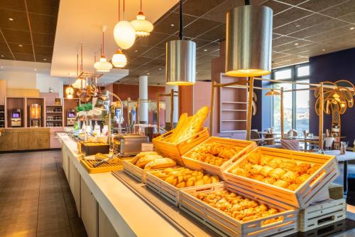 a bakery with baskets of donuts on a counter at ibis Paris Coeur d'Orly Airport in Orly