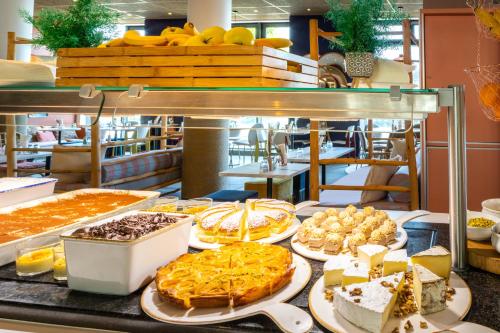 a buffet with many different types of pies and desserts at ibis Paris Coeur d'Orly Airport in Orly