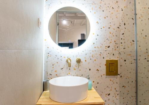 a bathroom with a white sink and a mirror at Nina's Traditional House by Estia in Valaneíon
