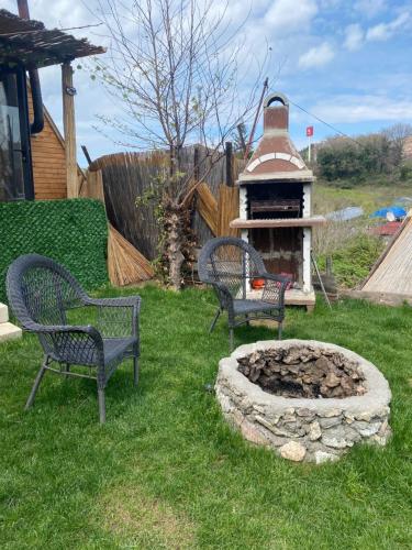 two chairs and a fire pit in a yard at Yalova Kasaba Bungalov in Çınarcık