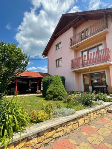 a house with a garden in front of it at Ubytovanie Marta Kováčová in Bešeňová