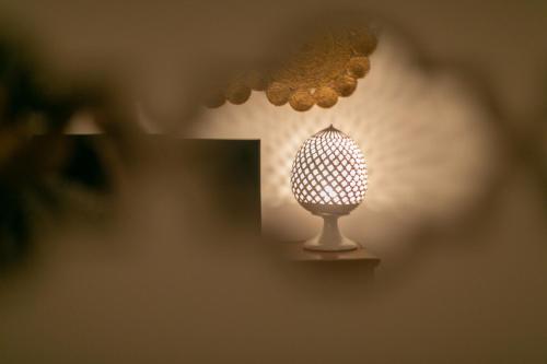 a small lamp is sitting on a wall at Trullo Alfieri - Relax e Garden in Alberobello
